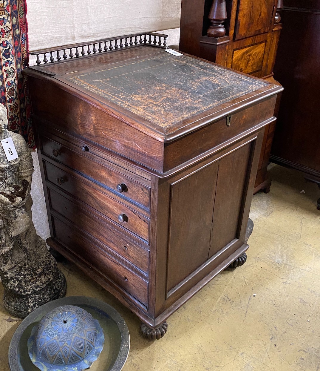 A William IV rosewood Davenport with sliding top, width 60cm, depth 64cm, height 89cm